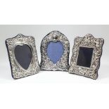 An Elizabeth II silver rectangular photograph frame of shaped outline, embossed with Cherubs and