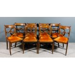 A set of eight George III mahogany dining chairs (including a pair of armchairs with scroll arms)