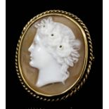 A late Victorian 9ct gold shell cameo set ring, the oval shell carved in high relief with the head