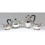 A George V silver rectangular four piece tea service with panelled bodies, angular loop handles