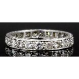 A 1930's silvery coloured metal mounted all diamond set full hoop eternity ring, the face channel