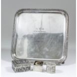 A George V silver square salver with gadroon mounts to rim and on four pad feet, 8.25ins square,