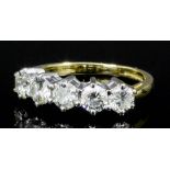 A modern 18ct gold mounted five stone diamond ring, the brilliant cut stones each approximately .