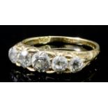 A late Victorian 18ct gold mounted five stone diamond ring, the central old cut stone of