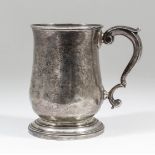 A George III silver baluster shaped tankard with moulded rim and foot rim and double C-scroll