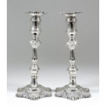 A pair of Elizabeth II silver pillar candlesticks of mid-18th Century design, with knopped stems and