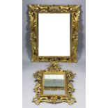 A 20th Century Florentine giltwood rectangular wall mirror, the frame pierced and carved with