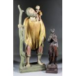 A 20th Century Continental carved, painted and gilt limewood figure of St Christopher carrying the