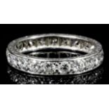 A modern silvery coloured metal mounted all diamond set full hoop eternity ring, the face set with