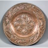 An early 20th Century Arts and Crafts embossed copper circular charger by John Pearson (1859-1930)
