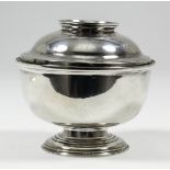 A George II plain silver circular sugar bowl and cover with moulded rim and footrim, the slightly