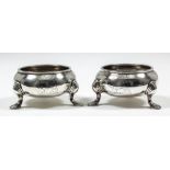 A pair of George II plain silver circular salts with moulded rims and on three pad feet, 3ins