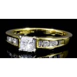 A modern gold and silvery coloured metal mounted diamond solitaire ring, the face set with a