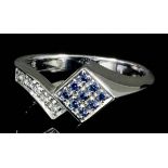 A modern 18ct white gold mounted sapphire and diamond ring, the face set with a chequer board of