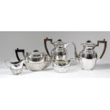 A Victorian and George V harlequin silver oval three piece tea service with part reeded bodies and