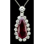 A modern silvery coloured metal mounted ruby and diamond pendant, the pear cut ruby approximately