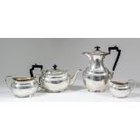 A George V silver oval four pierce tea service with bead mounts, the bodies engraved with ribbon and