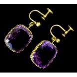 A pair of Edwardian gold coloured metal and amethyst set pendant drop earrings (with screw