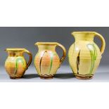 Clive Bowen (born 1943) - Three ovoid pottery jugs of graduated size, painted in green and brown