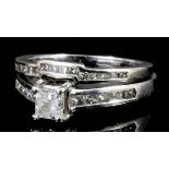 A modern 14k white gold mounted diamond solitaire, the princess cut stone of approximately .33ct,