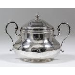 An 18th Century French silver two-handled sugar bowl and cover with turned finial, with plain