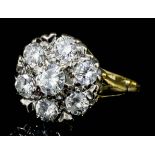 A modern 18ct white and yellow gold mounted all diamond set flowerhead pattern ring, the face set