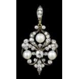 A late Victorian gold coloured metal mounted pearl and diamond set pendant, the central old cut