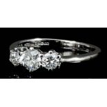 A modern 18ct white gold mounted three stone diamond ring, the central brilliant cut stone of