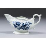 An English 18th Century blue and white porcelain low cream boat of silver shape, printed to both