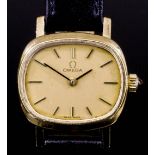 A 1980's lady's 9ct gold cased Omega wristwatch, the oblong gilt face with baton numerals, contained