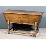 An 18th Century elm dough bin with moulded edge to top, on turned legs and plain stretchers, 47ins