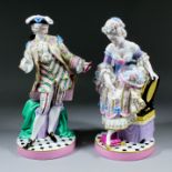 A pair of late 19th Century Continental porcelain figures of a gentleman and lady in 18th Century