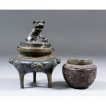 A Chinese bronze two-handled tripod censer and cover, the cover with dog of fo finial, the base