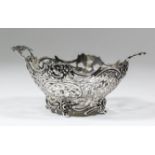 A Dutch silvery metal oval two-handled sweetmeat basket with scroll moulded rim cast with floral