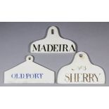 A Wedgwood creamware wine bin label of coat-hanger form, painted in blue "Old Port", 5.5ins wide,