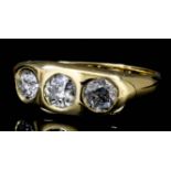 A George V gentleman's 18ct gold and diamond set three stone gypsy ring, the central old cut diamond