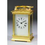 A late 19th/early 20th Century French carriage timepiece, the cream enamel dial with Roman numerals,