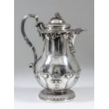 A William IV silver coffee jug, the bulbous body embossed with leaf and floral ornament and with