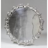 A George V silver circular salver, the shaped and moulded rim cast with shell and scroll ornament
