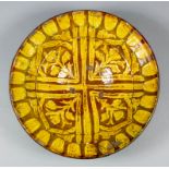 An 18th Century slip ware circular dish, the interior decorated in cream slip with tulip design on