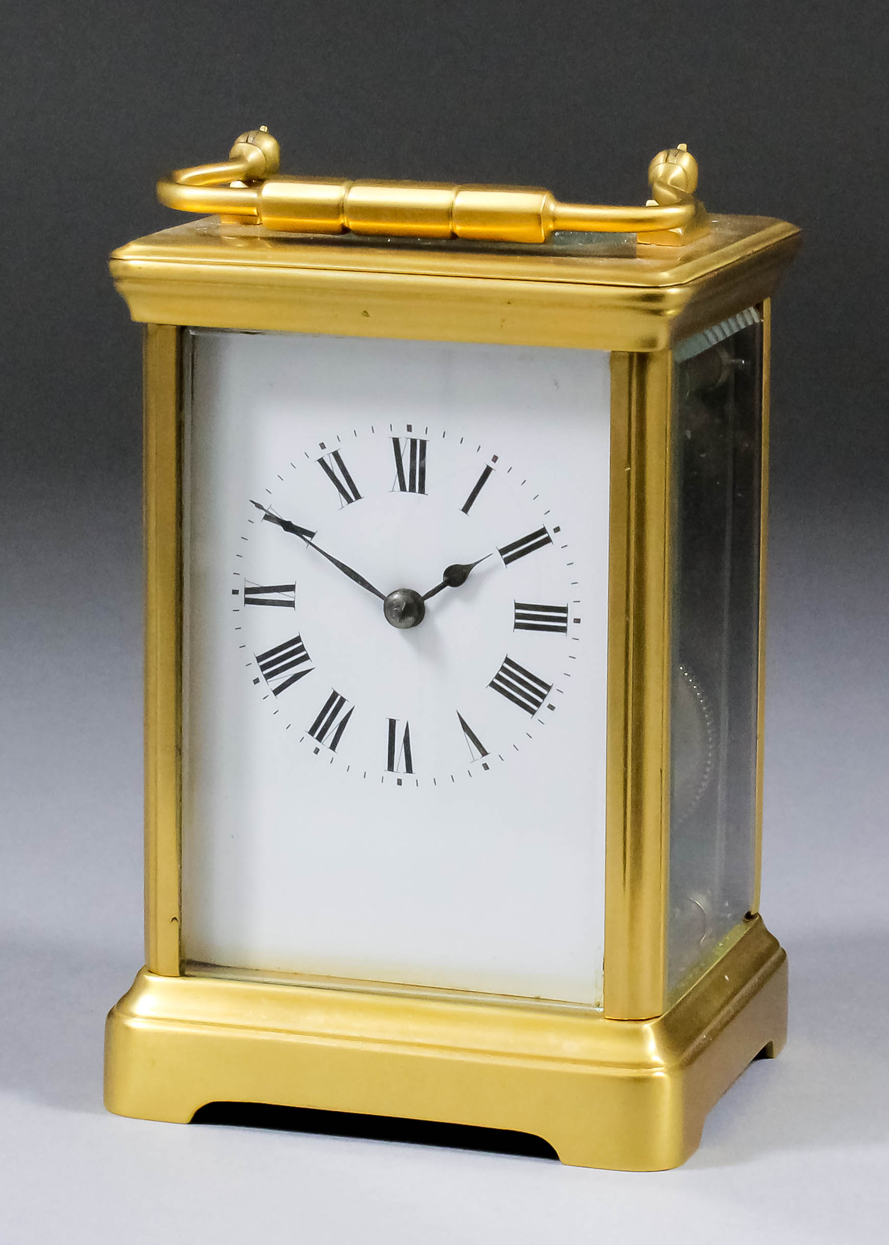 A late 19th Century French carriage clock, the white enamel dial with Roman numerals, to the eight