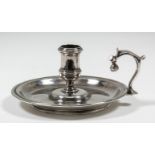 A good George II plain cast silver circular chamber candlestick with moulded edge and open scroll