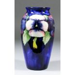 A Moorcroft pottery baluster-shaped vase, tube-lined and decorated in colours with "Pansy" design,