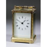 A late 19th Century French carriage clock, the white enamel dial with Roman numerals, to the eight