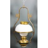 A lacquered brass hanging oil lamp with white opaque spherical glass shade, 17ins high overall,