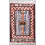 A modern Turkmen silk rug, the centre with bold cross motif filled with geometric motifs, field