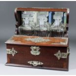 A late Victorian oak and plated metal mounted three bottle tantalus/cigarette box with twin