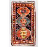 A Kazak Karachop rug woven in colours with three bold octagonal motifs, animals and samovars, on a