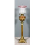 A late 19th Century brass oil lamp, the Corinthian column with acanthus capital, on a stepped base