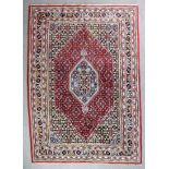 A Bidjar carpet woven in colours with octagonal central medallion filled with stylised lozenge and